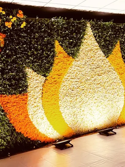 A different perspective of the floral lotus wall, showing how the uplighting accentuates the vibrant colors and intricate details of the flower arrangement.