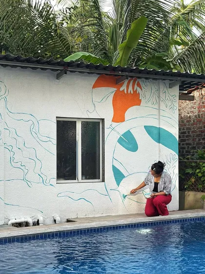 The beginning stages of the huge Alibaug poolside mural. Here I am mapping out the initial design and adding the first blocks of colour right by the water's edge.