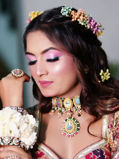 The eye makeup for the Mehendi look is bright and shimmery, making the eyes the center of attention.