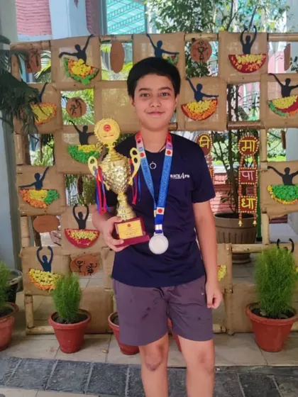 Viraaj Mishra with his silver medal and trophy. Representing his school, he demonstrated the skill and competitive spirit we instill in all our players.