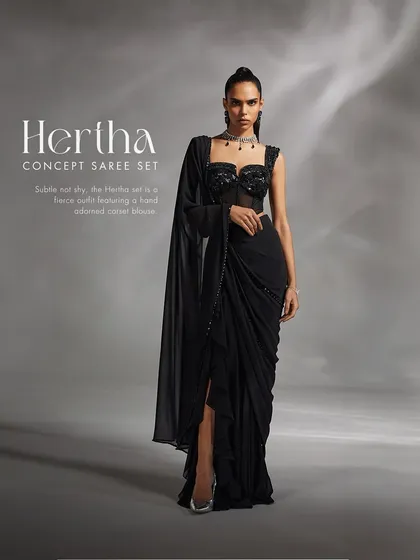 The Hertha Concept Saree in timeless black. This fierce and modern outfit features a hand-adorned corset blouse paired with a pre-draped concept saree, designed to amplify your look with sophisticated elegance.