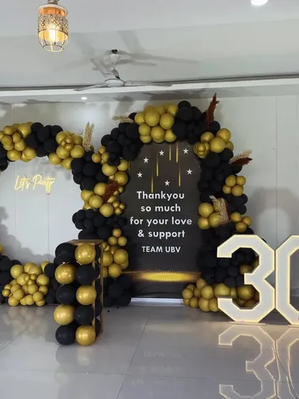 I also handle corporate and milestone celebrations. For this event celebrating '30M', I created a large balloon installation in black and gold, with custom signage and large marquee numbers.