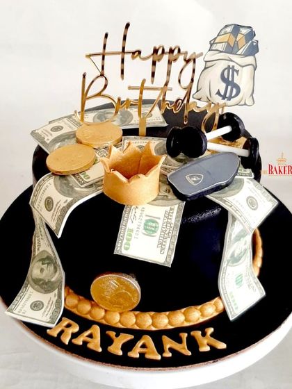 An elegant black and gold cake for a husband's birthday. Saima wanted to include all the things her husband loves, so I incorporated edible dollar bills, dumbbells, and a car key. It’s a fun, personalized, and luxurious design.