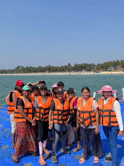 Our group in life jackets on the floating platform at Malpe beach, ready for water sports.