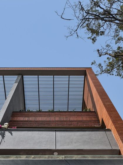 Different angles of the brick facade and pergola, showing how the design captures the sky. These framed views are intentionally designed to connect the residents with the open sky and surrounding nature.