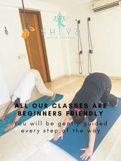 You do not need any prior experience to join my classes. This image shows students in Adho Mukha Svanasana, or Downward Facing Dog, a foundational yoga pose. I guide everyone gently, ensuring you learn the correct alignment to build a safe and strong practice from day one.
