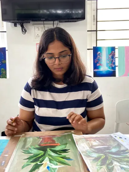 A student in our acrylics course working on a pineapple painting. The courses allow you to explore different subjects and styles.