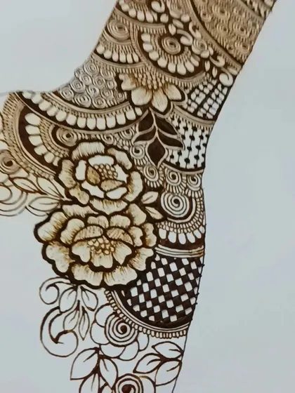 A practice sketch of a floral and checkerboard pattern, common elements in traditional Indian mehndi.