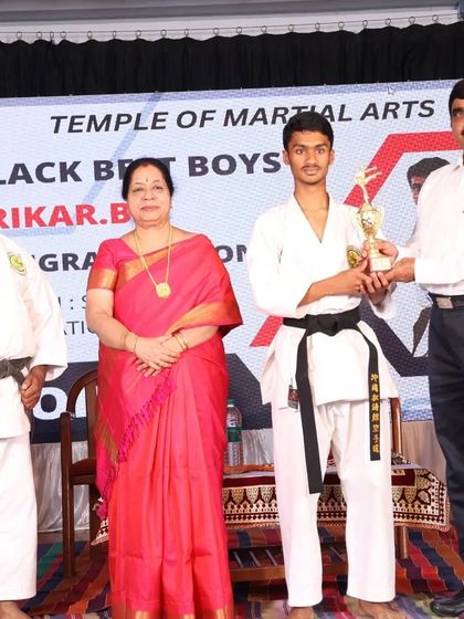 A moment of pride for one of our top male students, recognized for his exceptional skill and spirit during the black belt grading.