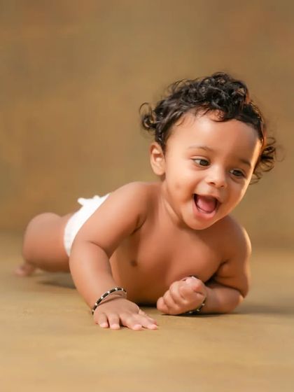The cutest little explorer on his tummy. This pose is great for babies who are strong and love to look around.