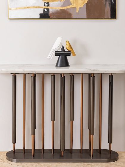The Timeless Console Table features a unique base with vertical rods in contrasting finishes, creating a striking visual effect. It’s the perfect piece to create a special focal point in your entry foyer or lobby.
