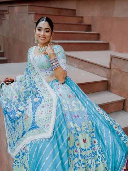 The bride looking fresh and vibrant in her blue Mehendi outfit. We love helping couples choose distinct looks for each of their wedding functions.