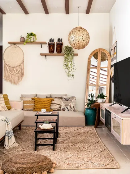 My design style is versatile. This cozy living room corner highlights an earthy, bohemian aesthetic, using natural textures like rattan and macrame, warm wood tones, and layered textiles to create a relaxed and inviting atmosphere.