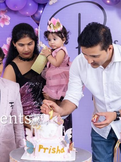 The family lighting the first birthday candle.