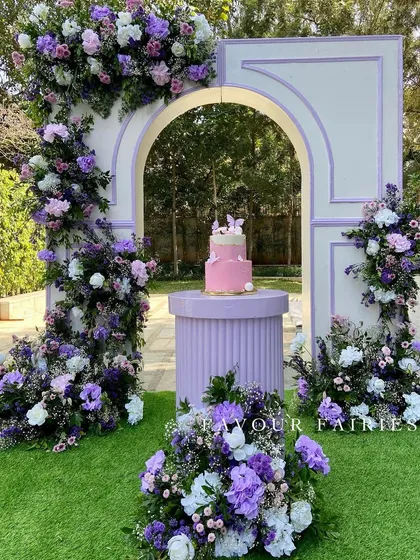 A beautiful cake deserves a beautiful backdrop. For this lavender-themed baby shower, we created a stunning floral archway in shades of purple and white, providing the perfect frame for the celebration's centerpiece.