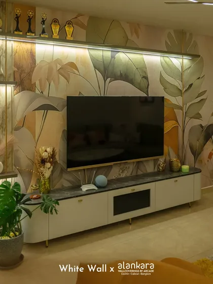 I believe walls are a canvas for art. Here, a custom botanical wallpaper from my collection serves as a stunning backdrop for a sleek, modern television unit, demonstrating how I integrate technology and nature-inspired design seamlessly.