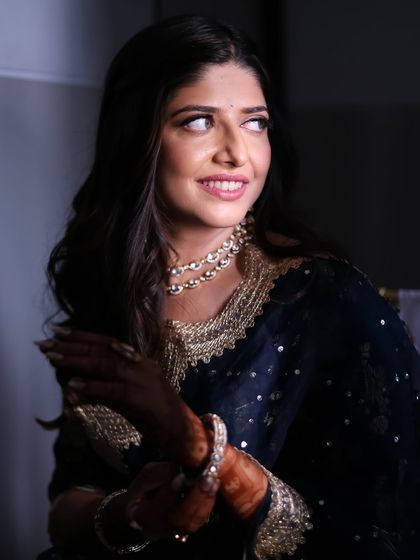 A candid moment showing the soft, glowing makeup. The look is designed to be beautiful from all angles, enhancing her features in a natural and elegant way.