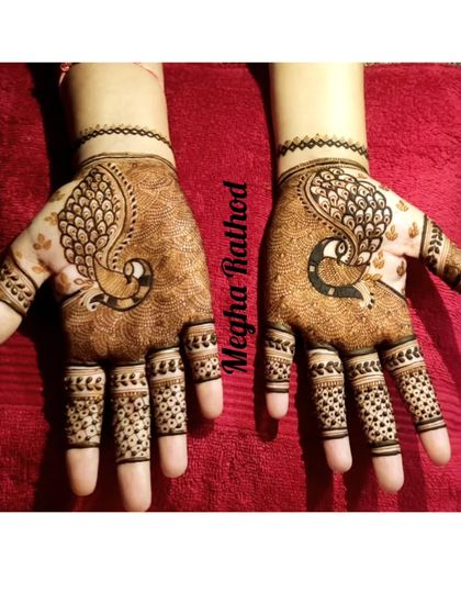 A simple yet elegant design featuring a single peacock on each palm, with dotted patterns on the fingers for a minimalist traditional look.