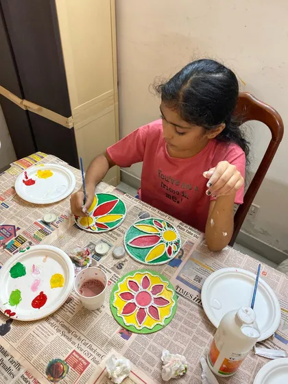 Concentration and creativity in action during our Diwali workshop. This young artist is carefully painting her Lippan art pattern. I provide all the materials and gentle guidance.