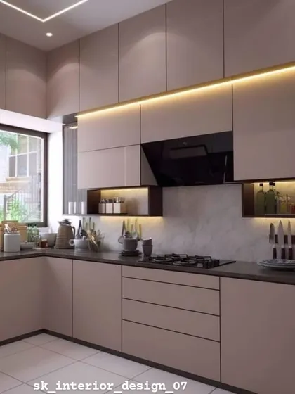 A beautiful kitchen with handle-less cabinets and open, backlit niches for storage and display. The large window allows for plenty of natural light.