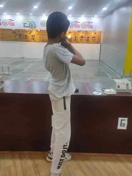 A young shooter learning the correct standing posture. Our basic courses cover all the fundamentals, from safety rules to proper shooting techniques.