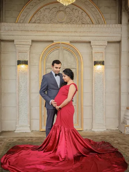 An elegant indoor portrait in front of a grand doorway. This setting adds a touch of sophistication and timelessness to the maternity shoot.