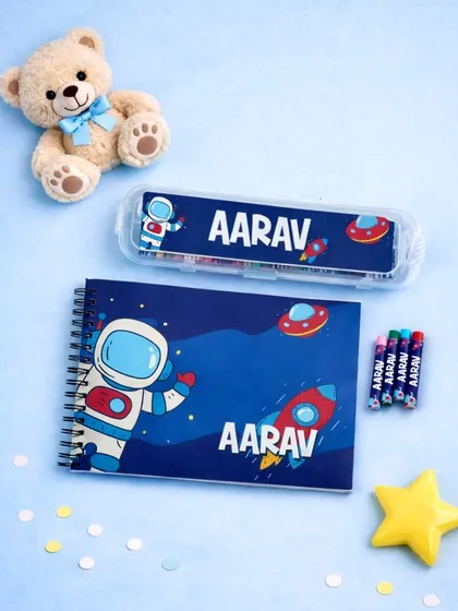 This personalized drawing set is a wonderful return gift for kids' birthdays. It includes a spiral-bound drawing book and a box of crayons, both customized with the child's name and a fun space theme.