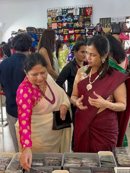 Here I am explaining the details of my handcrafted items to a customer at the Suryavanshi Hall exhibition. I love sharing the story behind each piece.