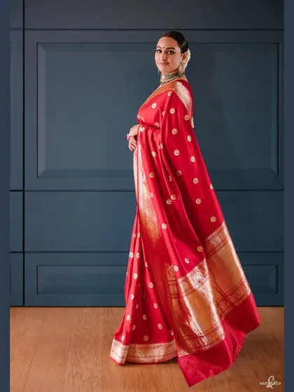 A full-length portrait of Sonakshi in her reception saree. The elegant pose and the beautiful drape of the fabric create a timeless and regal image.