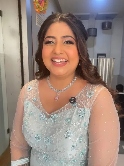 A bright, happy smile from this client on her engagement day. Her makeup is fresh and radiant, paired with a simple yet elegant hairstyle.