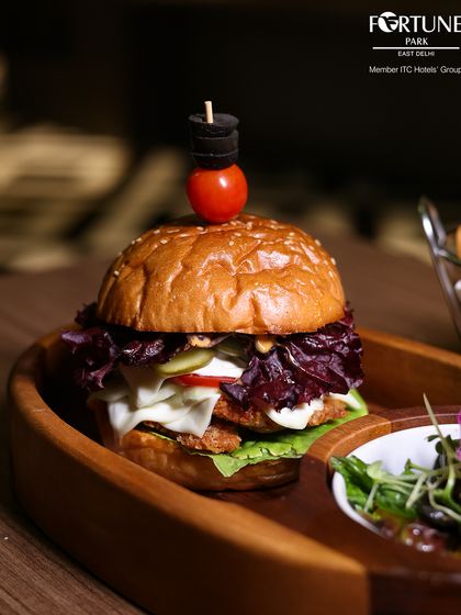 Our juicy gourmet burger, stacked high with fresh lettuce, cheese, and a perfectly cooked patty, is a satisfying choice for any meal.