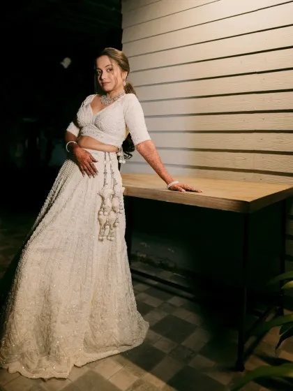 An ethereal all-white lehenga look, perfect for a reception or engagement. The makeup is kept soft and luminous to complement the intricate chikankari work.