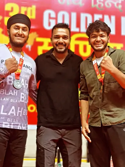 Posing with two of my fighters after they won medals at a national competition. Their smiles show the reward of dedication.