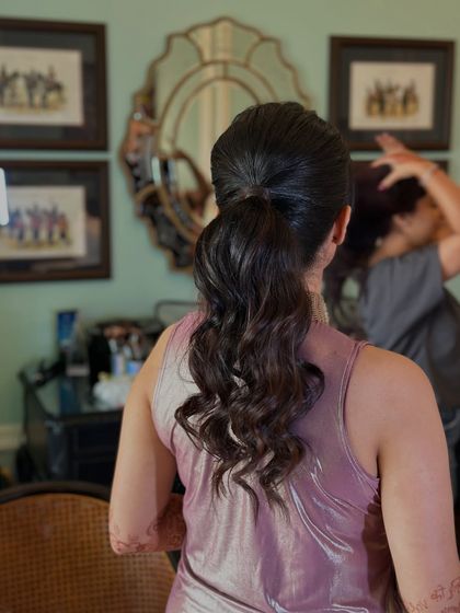 A soft, textured ponytail with gentle waves. This is a great go-to style for a wedding guest who wants to look chic and put-together.