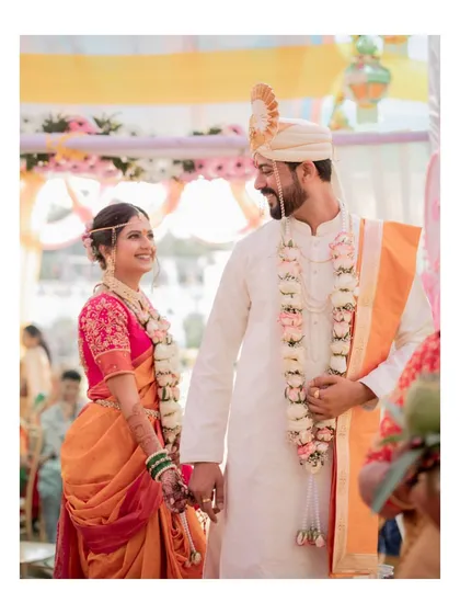 A classic Maharashtrian wedding moment, as the bride and groom share their first look as husband and wife.
