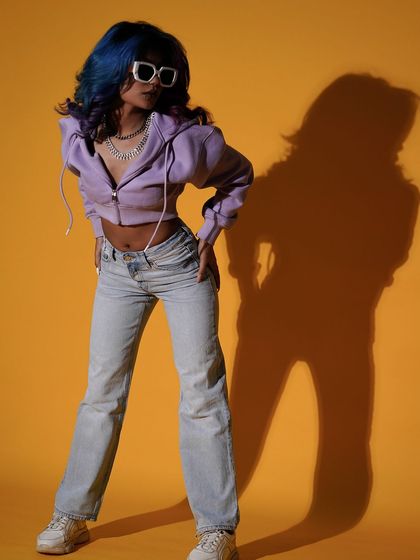 I love experimenting with shadows in my studio work. Here, the model's shadow becomes a character in itself, adding depth and a graphic quality to this vibrant shot against a bold yellow background.