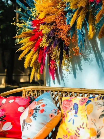 A close-up of the photo booth seating, showing the mix of colorful printed cushions that add to the fun and eclectic carnival theme.