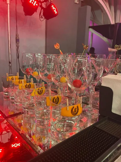 A bar ready for action, with glasses prepped with custom-stamped garnishes and other fresh fruit.
