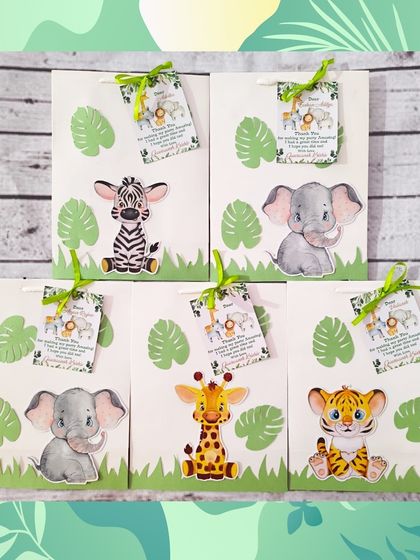 The custom paper bags for the jungle theme feature adorable animal cutouts like a tiger, zebra, elephant, and giraffe, making the gift exciting before it's even opened.
