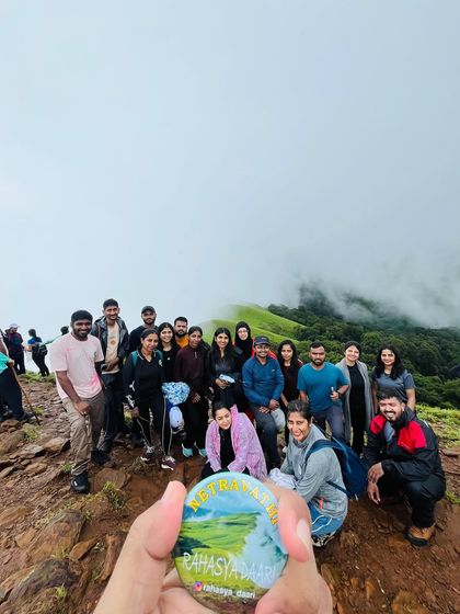 Our group at the top of Netravathi Peak, with our custom trek badge in the foreground. A perfect memory of a challenging and beautiful climb.