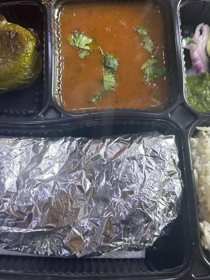 A special thali with rajma and stuffed capsicum. The capsicum is filled with a savory potato mixture and cooked in a light gravy.