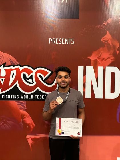 Ayaan, a human highlight reel, shows off his bronze medal. He won three fights by triangle choke, showcasing the effectiveness of our submission focused system.