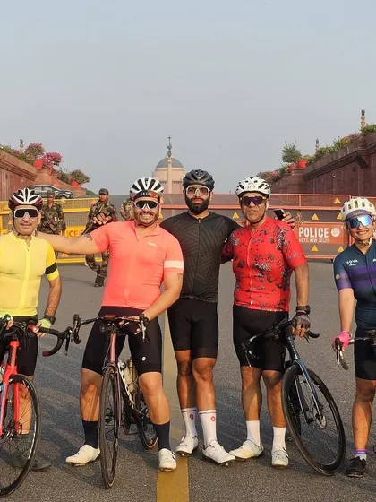 A group of five riders posing together.