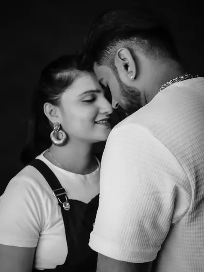 Sometimes, the most powerful moments are the quiet ones. This black-and-white close-up captures the gentle intimacy and connection between partners, creating a timeless and artistic pregnancy portrait.