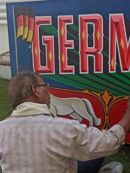 Another angle of me painting the "Germany in India" canvas outdoors at the event location.