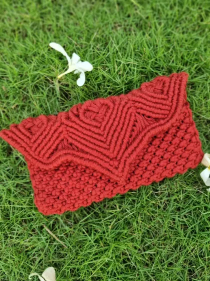 This bold red macrame clutch was a custom piece made with love. The intricate chevron pattern and rich color make it a statement accessory, perfect for adding a pop of personality to your ensemble.