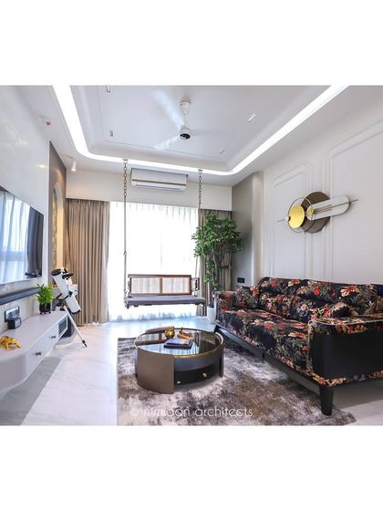 A full view of the 'Atmosphere' living room, showcasing the mix of a floral sofa, a modern swing, and contemporary art. This space is a testament to our belief that a home should tell your story.