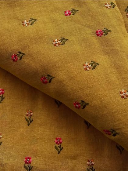 Our embroidered linen in a rich mustard yellow. The small, colorful floral butis add a touch of charm to this breathable and comfortable fabric.