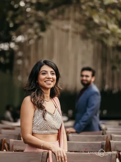 A beautiful candid portrait of the bride-to-be at her engagement party, with her fiancé looking on from the background.