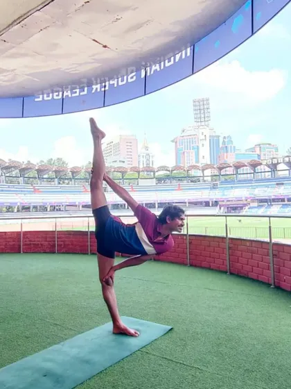 Here I am holding a standing split, or Urdhva Prasarita Eka Padasana, at the Sree Kanteerava Stadium. This posture demonstrates advanced flexibility and balance, key components we develop in my classes.